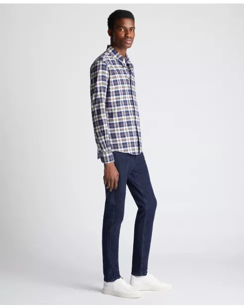 Man wearing a plaid shirt and navy pants on a white background