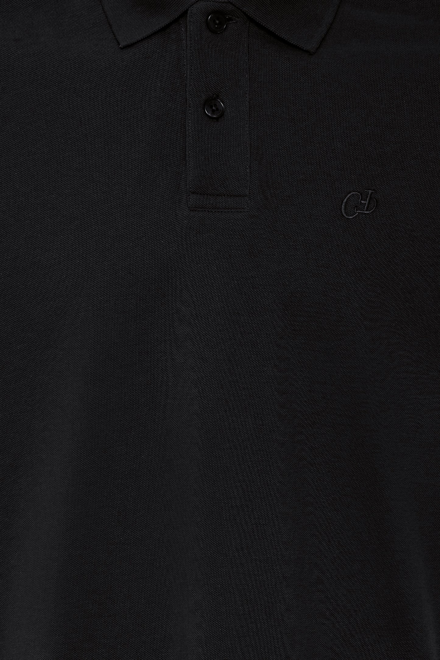 Close-up of a black polo shirt with buttons and a brand logo.
