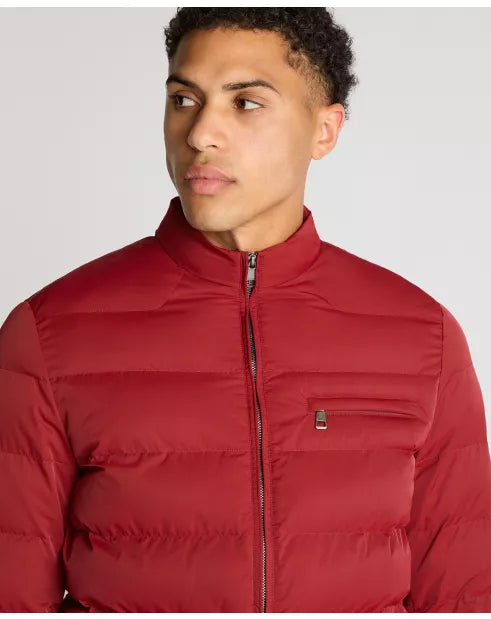 Man wearing a red puffer jacket against a plain background