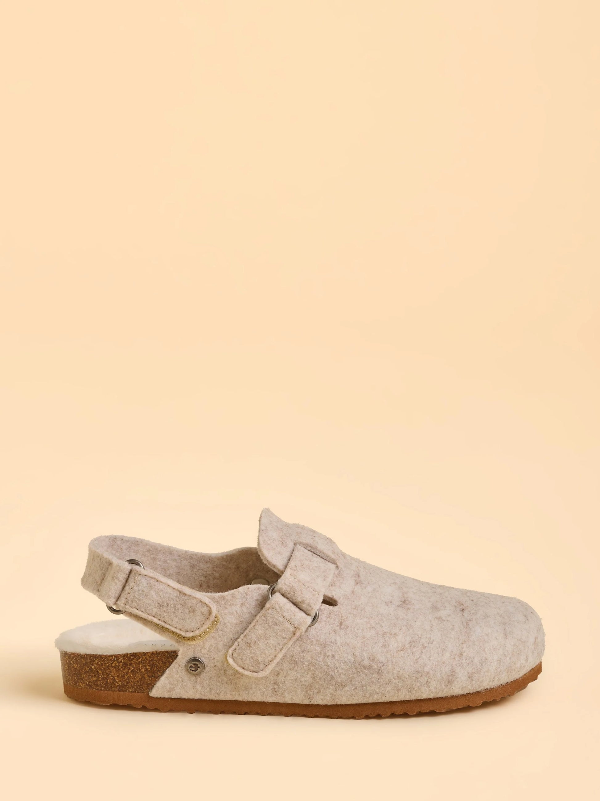 Single clog shoe on a beige background