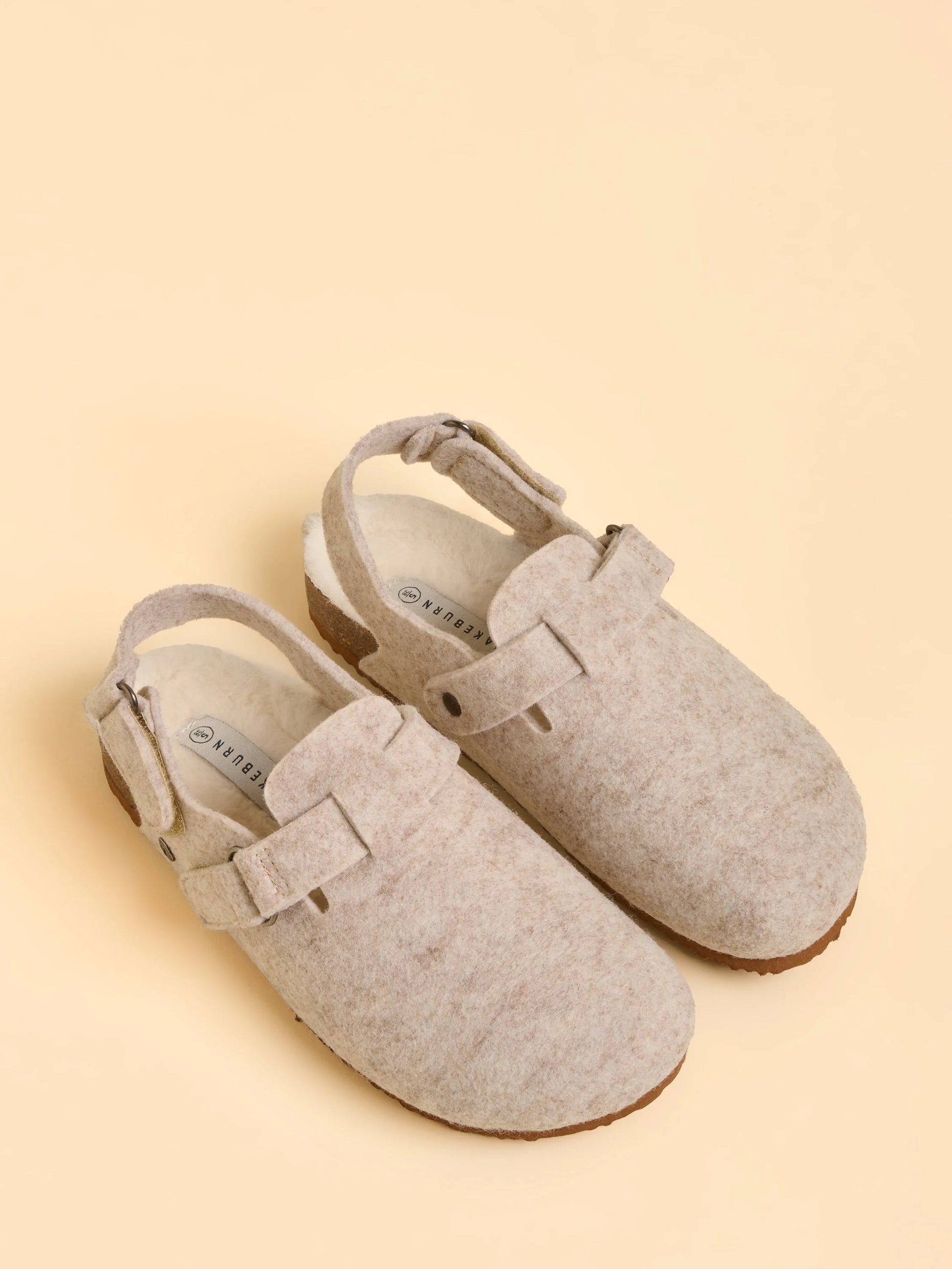 Pair of gray clogs on a beige background
