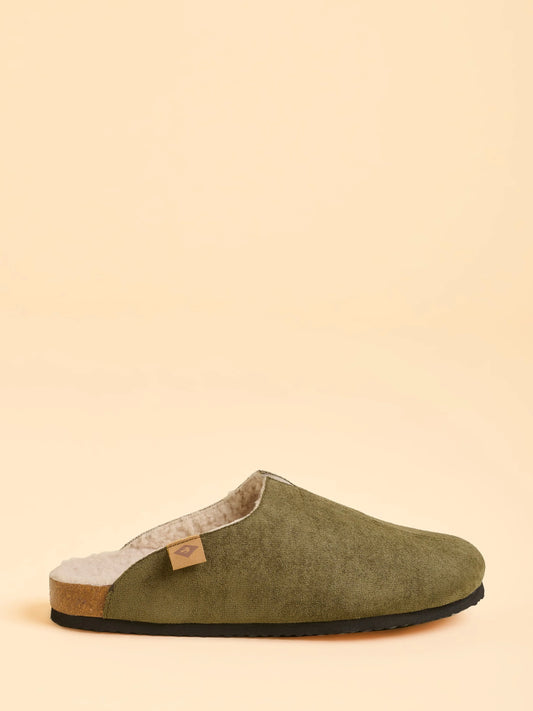 Green slipper on a beige background