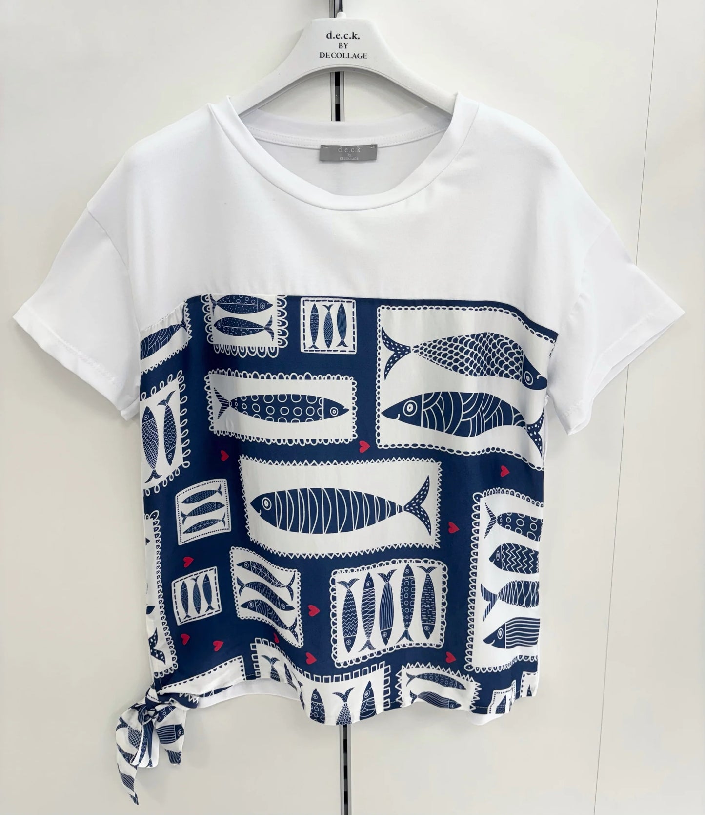 White t-shirt with blue fish pattern on a white background