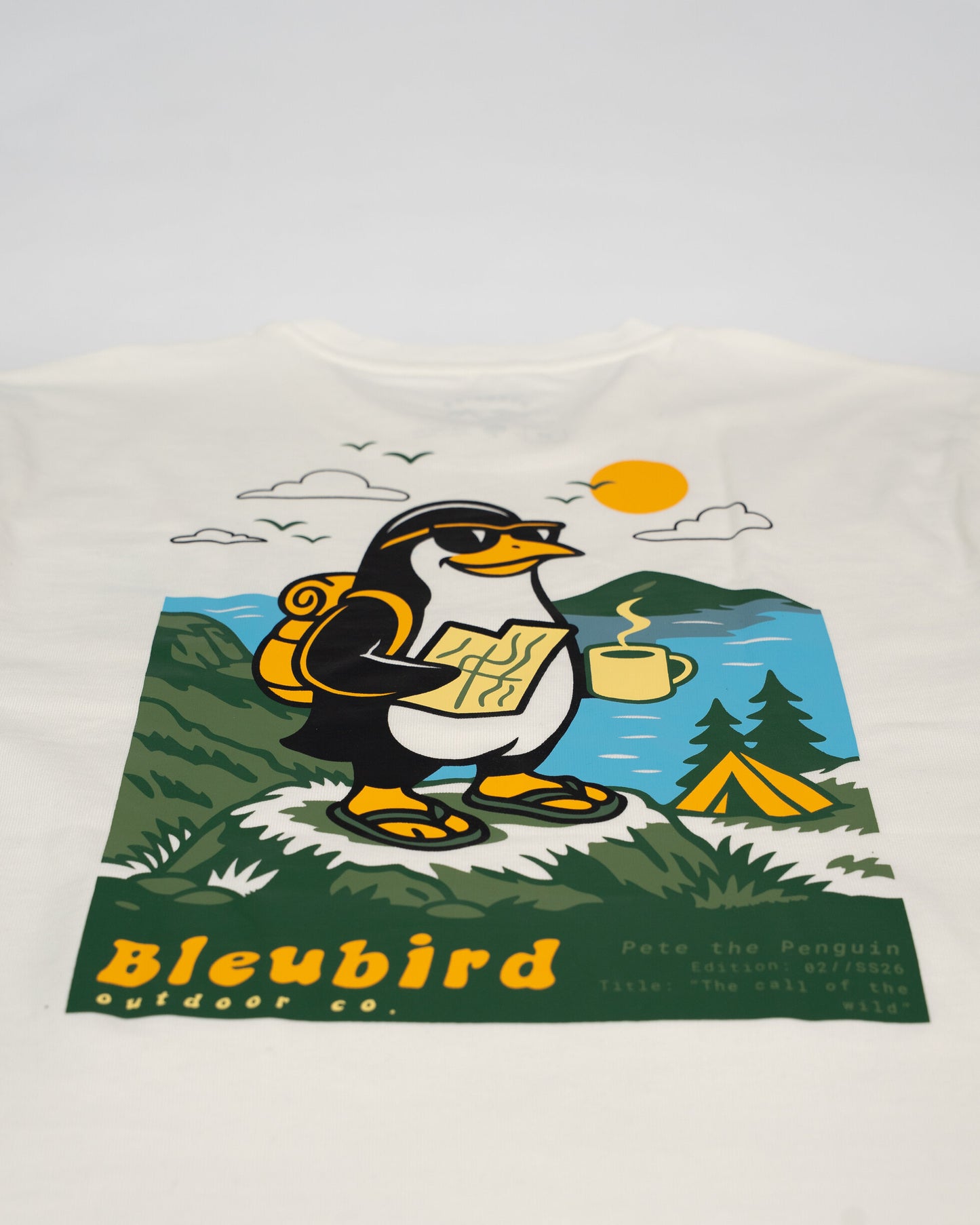 T-shirt with a penguin design and 'Bleubird Outdoor Co.' branding on a white background