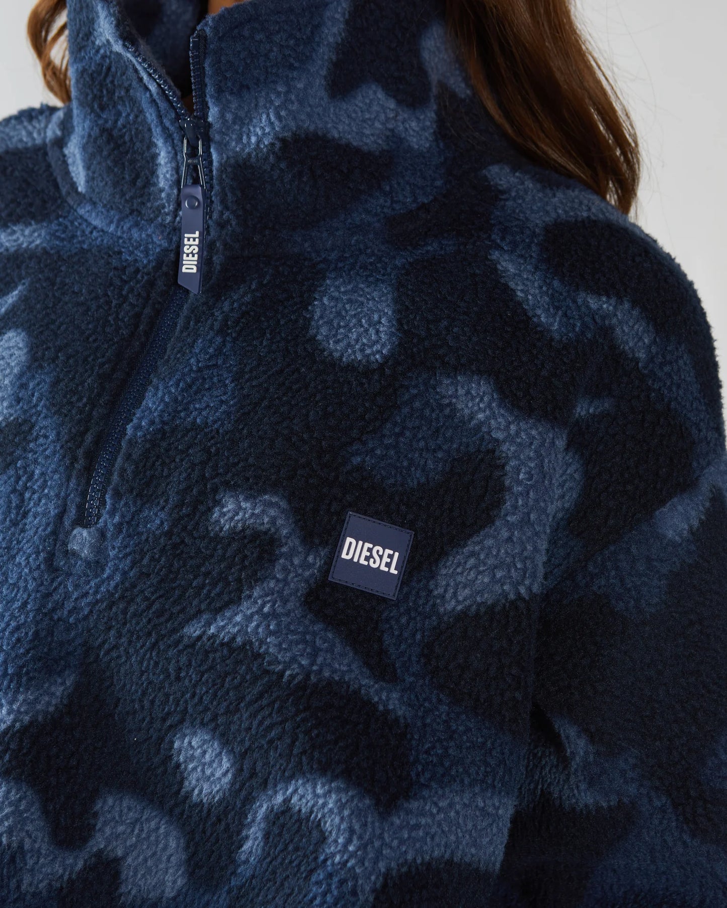 Navy blue camouflage fleece jacket with Diesel logo on a plain background