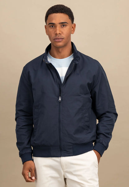 Man wearing a navy blue jacket on a beige background