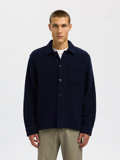 Man wearing a navy blue jacket on a white background
