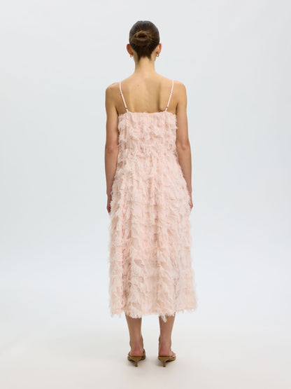Woman wearing a pink lace dress on a white background