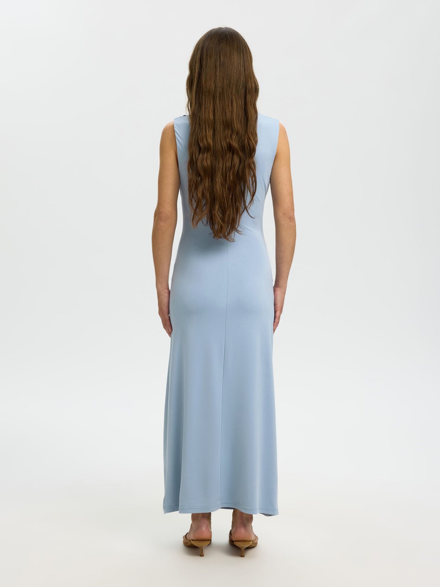 Woman wearing a light blue dress on a white background