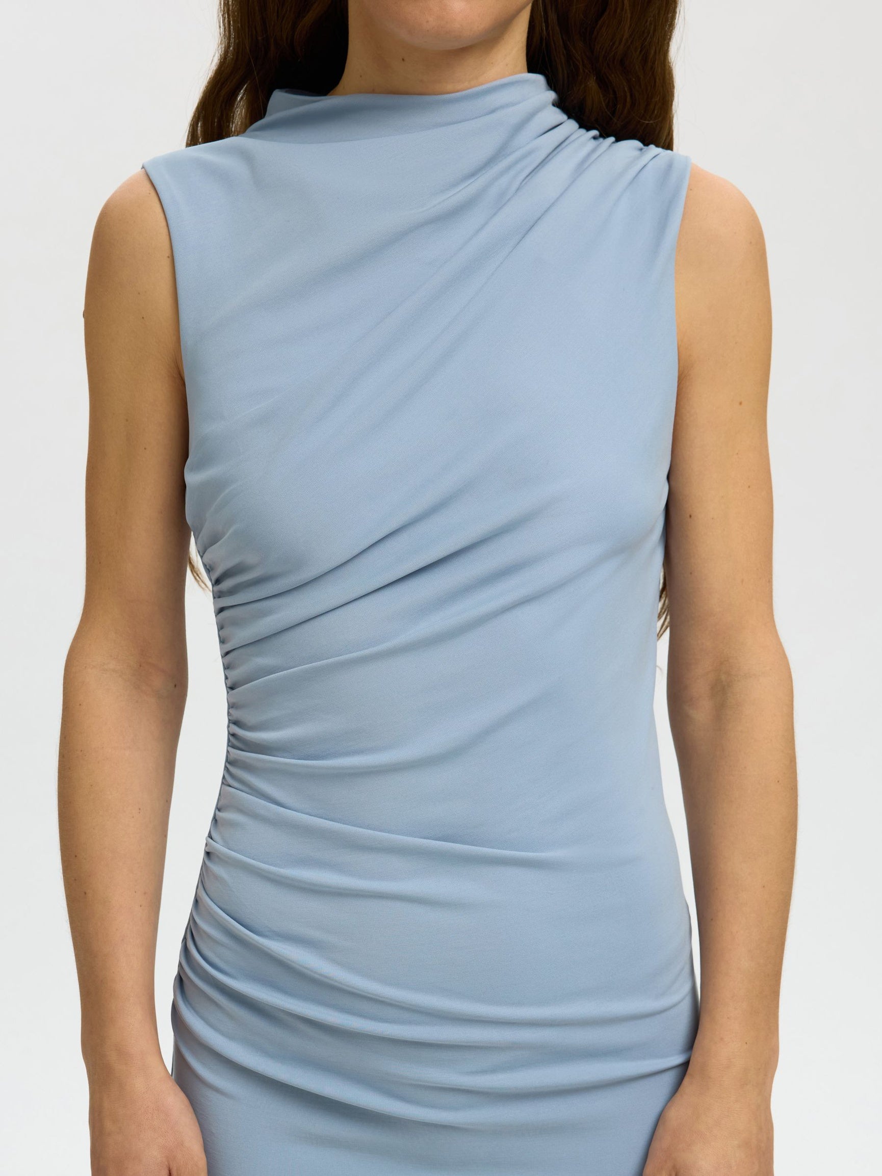 Light blue sleeveless dress worn by a person on a white background