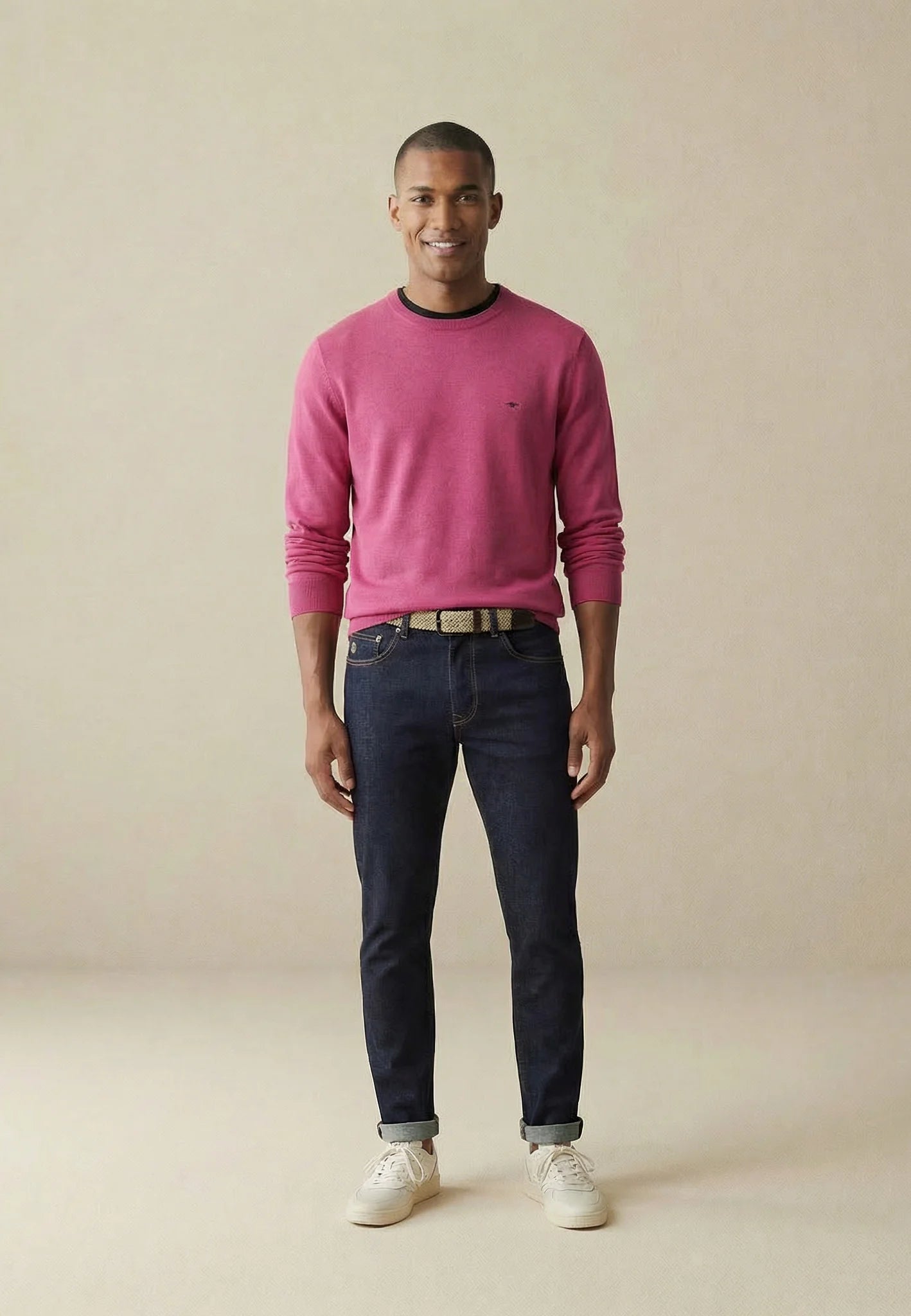 Men wearing pink jumper with dark denim jeans 