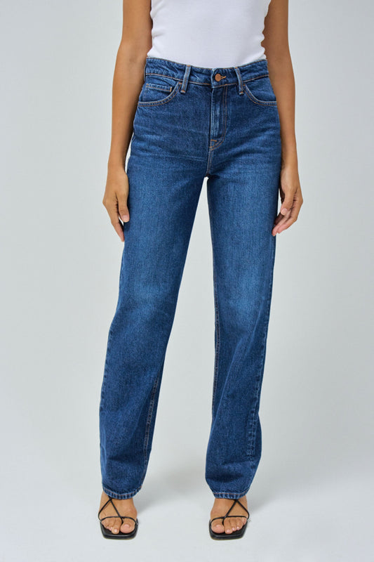 Person wearing blue jeans on a white background