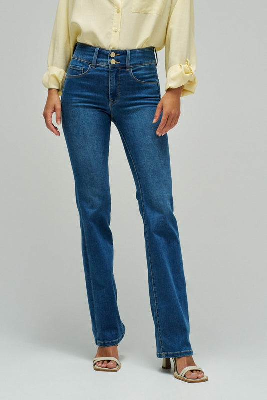 Person wearing blue jeans and a yellow shirt on a plain background