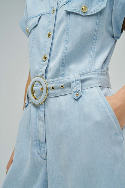 Light blue denim dress with a belt on a neutral background