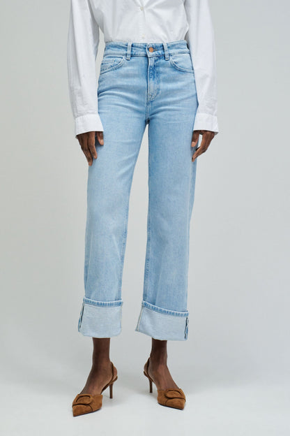 Light blue jeans worn by a person on a white background