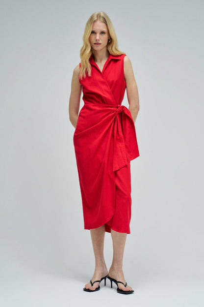 Woman wearing a red dress on a light gray background