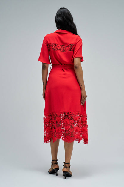 Red dress with lace details on a gray background