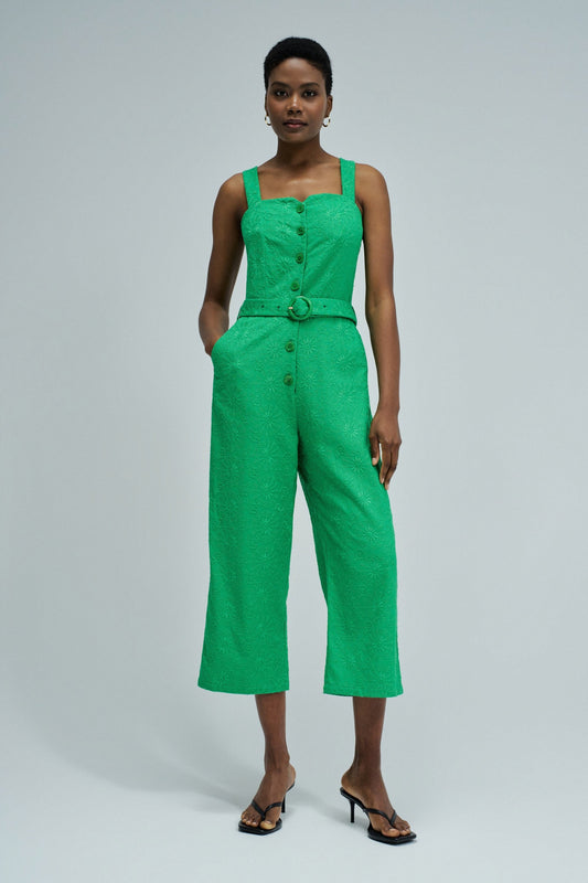 Woman wearing a green jumpsuit on a white background