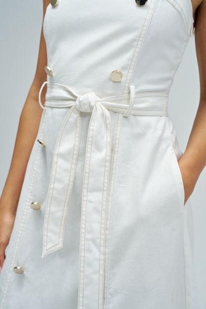White denim dress with a belt on a plain background