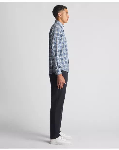 Man wearing a blue plaid shirt and black pants on a white background
