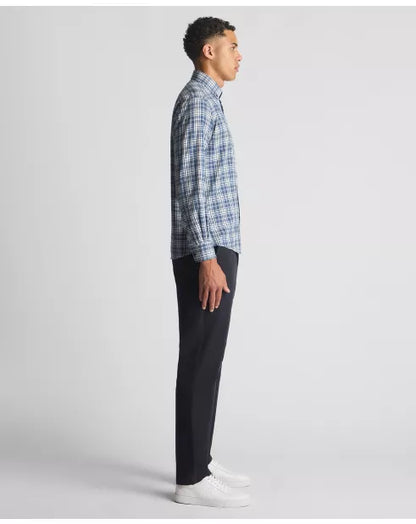 Man wearing a blue plaid shirt and black pants on a white background