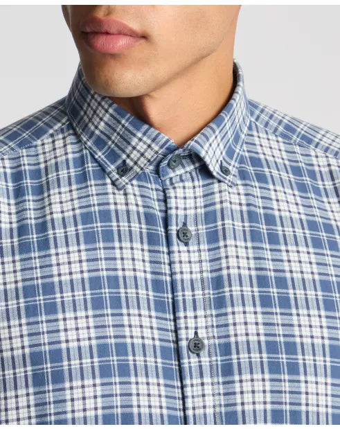 Close-up of a person wearing a blue and white checkered shirt.