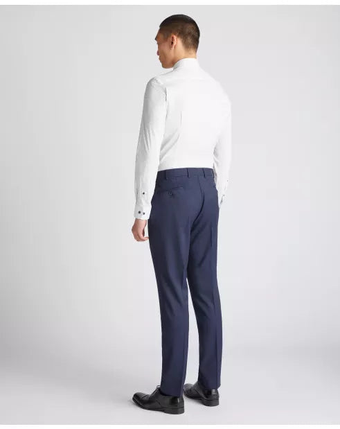 Man wearing a white dress shirt and navy pants on a white background