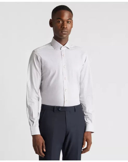 Man wearing a white dress shirt and dark pants on a light gray background