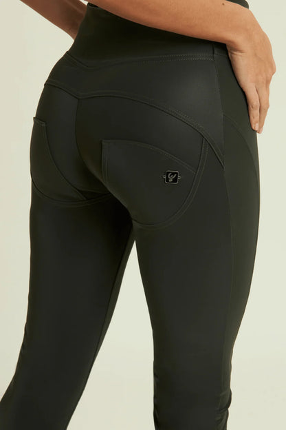 Black leggings with a brand logo on a beige background
