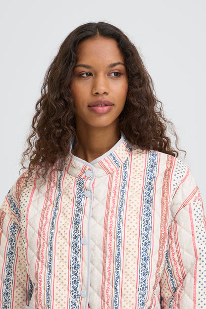 Woman wearing a patterned shirt against a white background