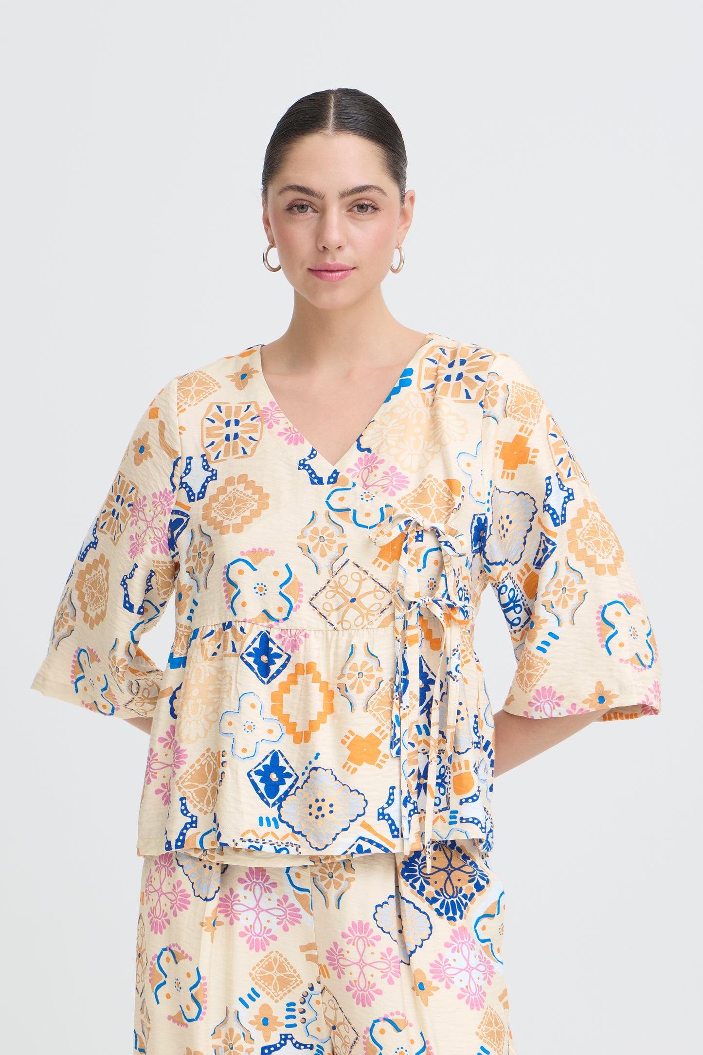 Woman wearing a floral blouse with a white background