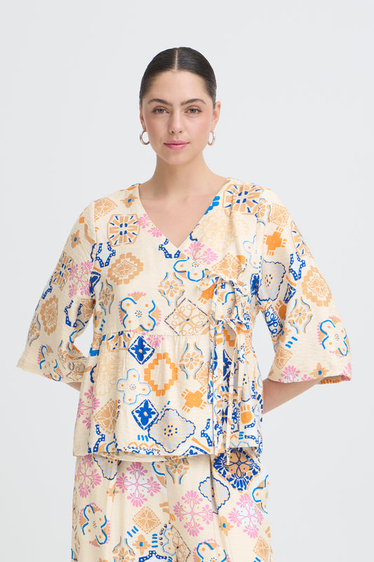 Woman wearing a floral blouse with a white background