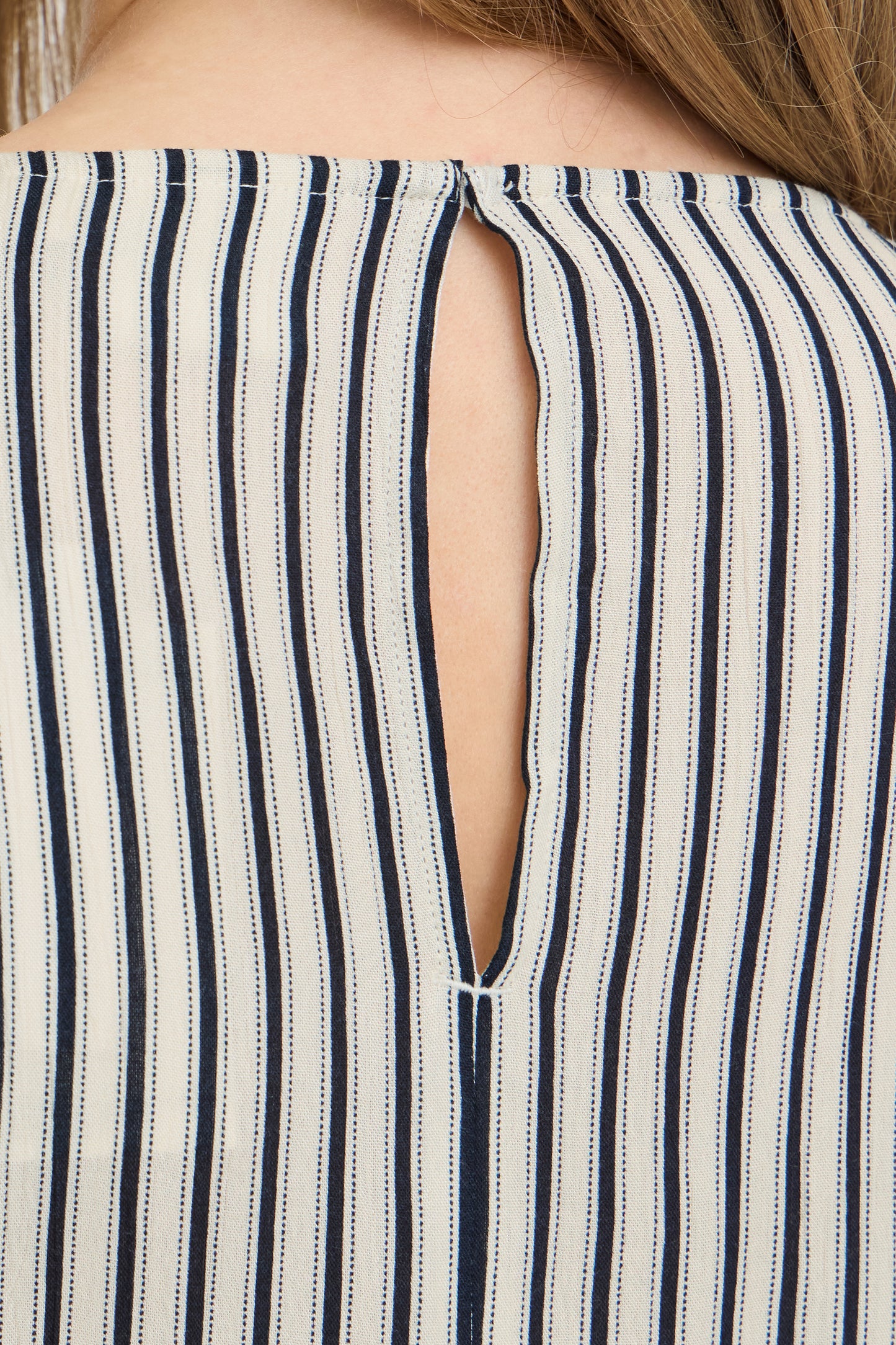 Close-up of a striped garment with a cut-out design.