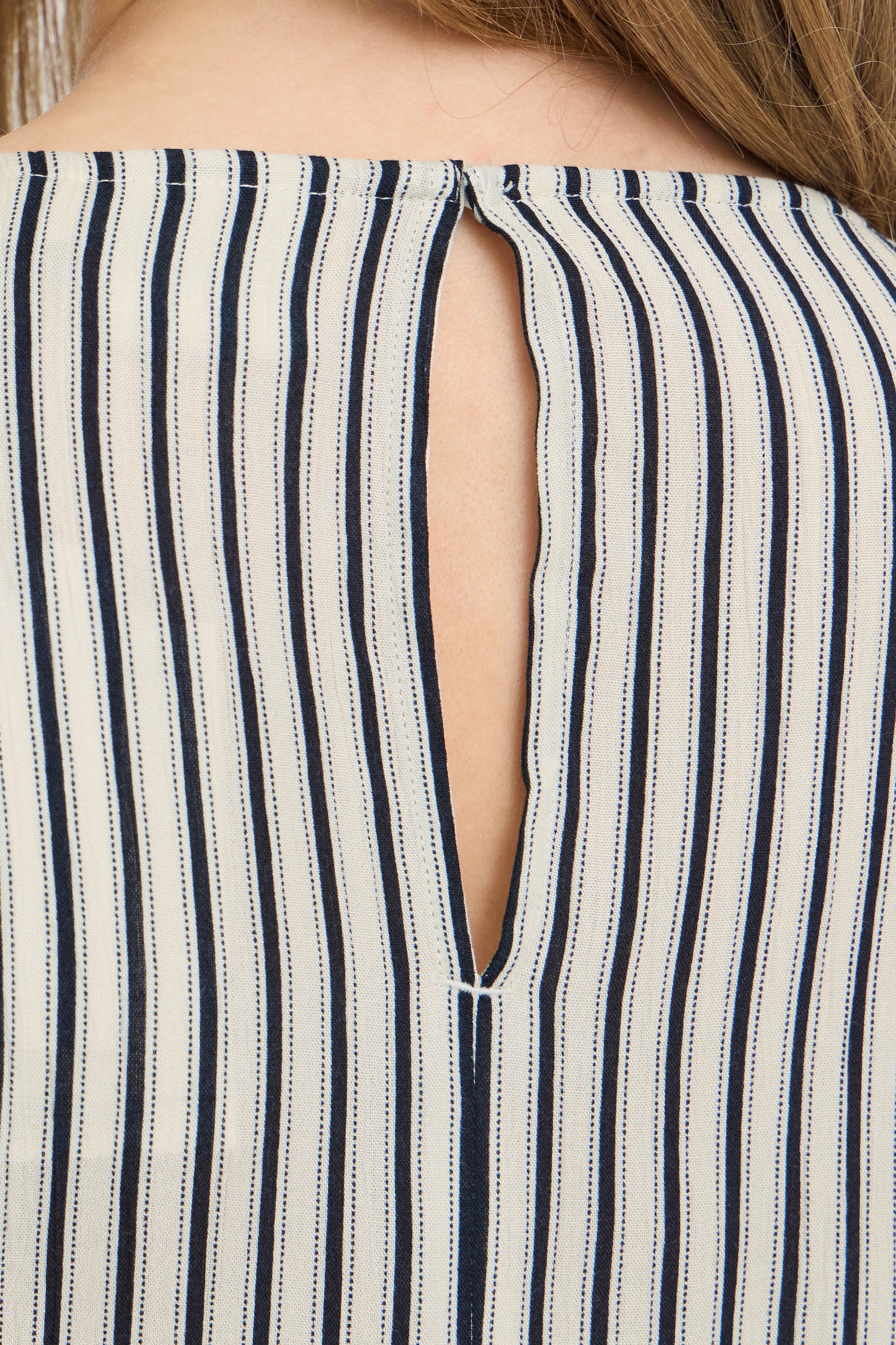 Close-up of a striped garment with a cut-out design.