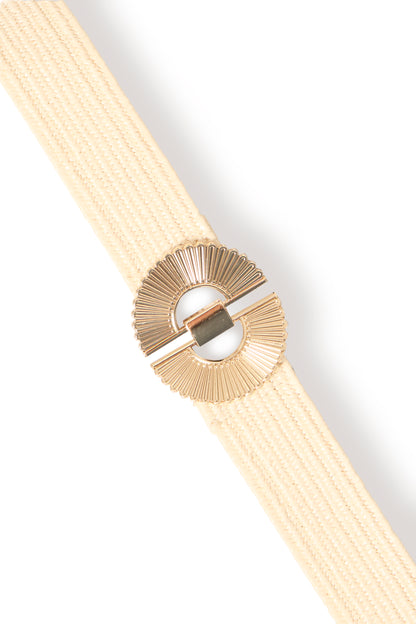 Beige belt with a gold buckle on a light gray background
