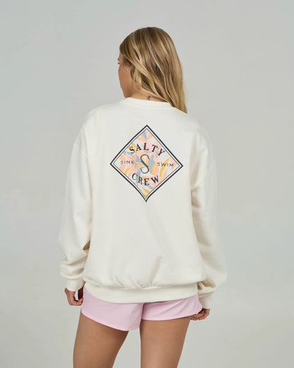 Person wearing a cream sweatshirt with a colorful logo on the back, standing against a plain background.