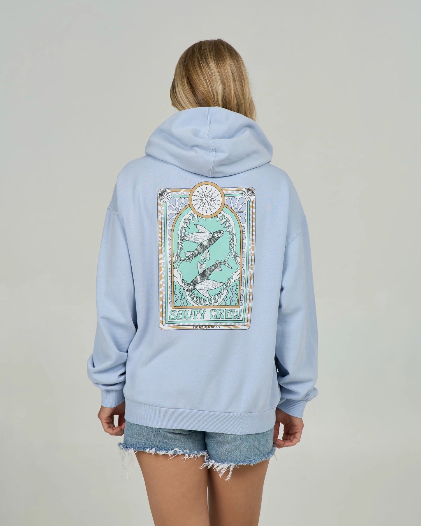 Light blue hoodie with a graphic design on the back worn by a person against a plain background