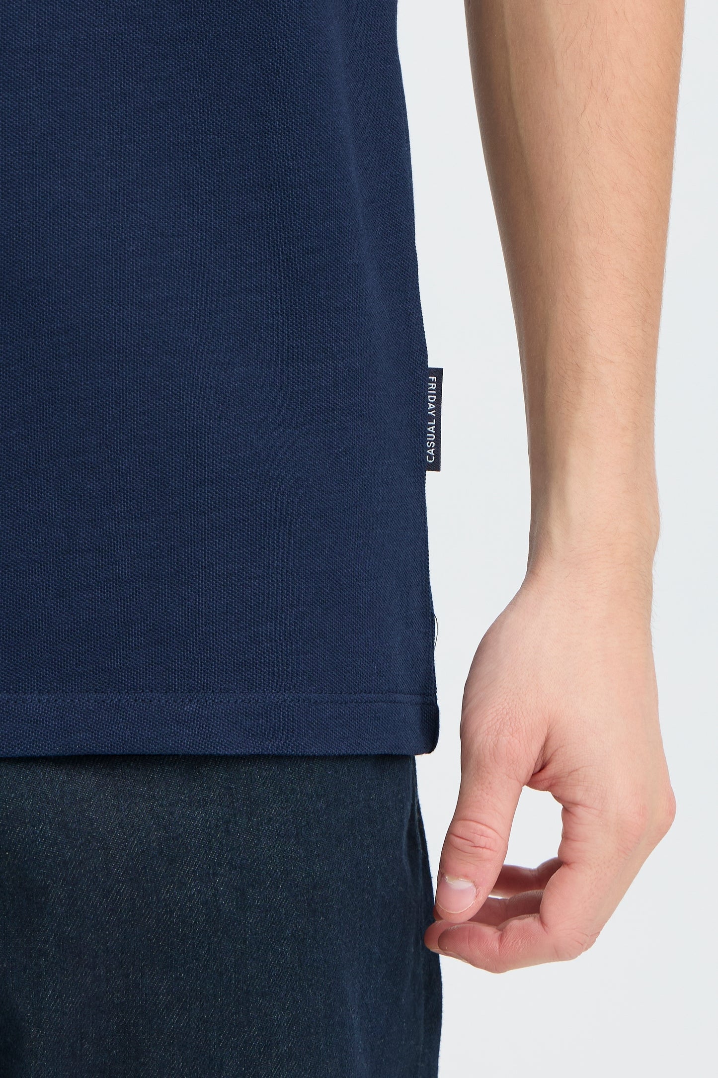 Navy blue t-shirt with a brand logo on the sleeve against a white background