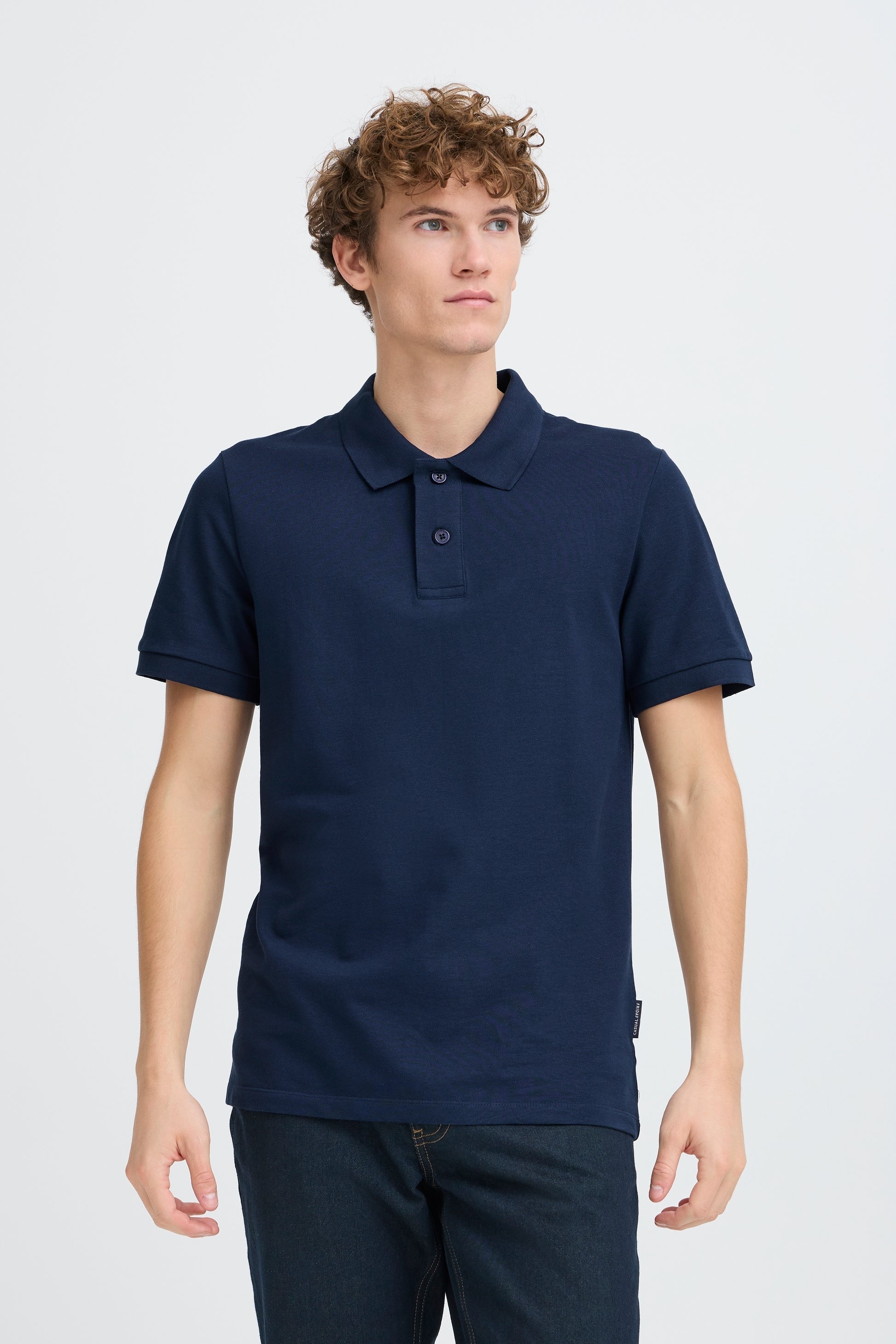 Man wearing a navy blue polo shirt on a white background
