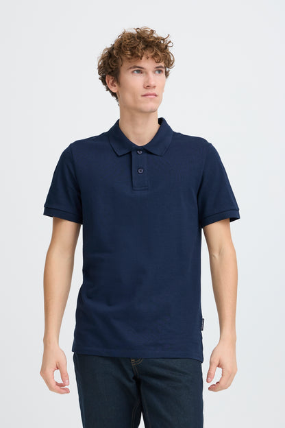 Man wearing a navy blue polo shirt on a white background
