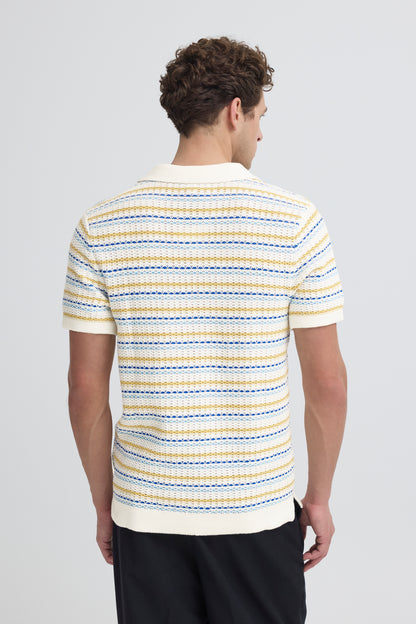 Man wearing a striped polo shirt on a plain background