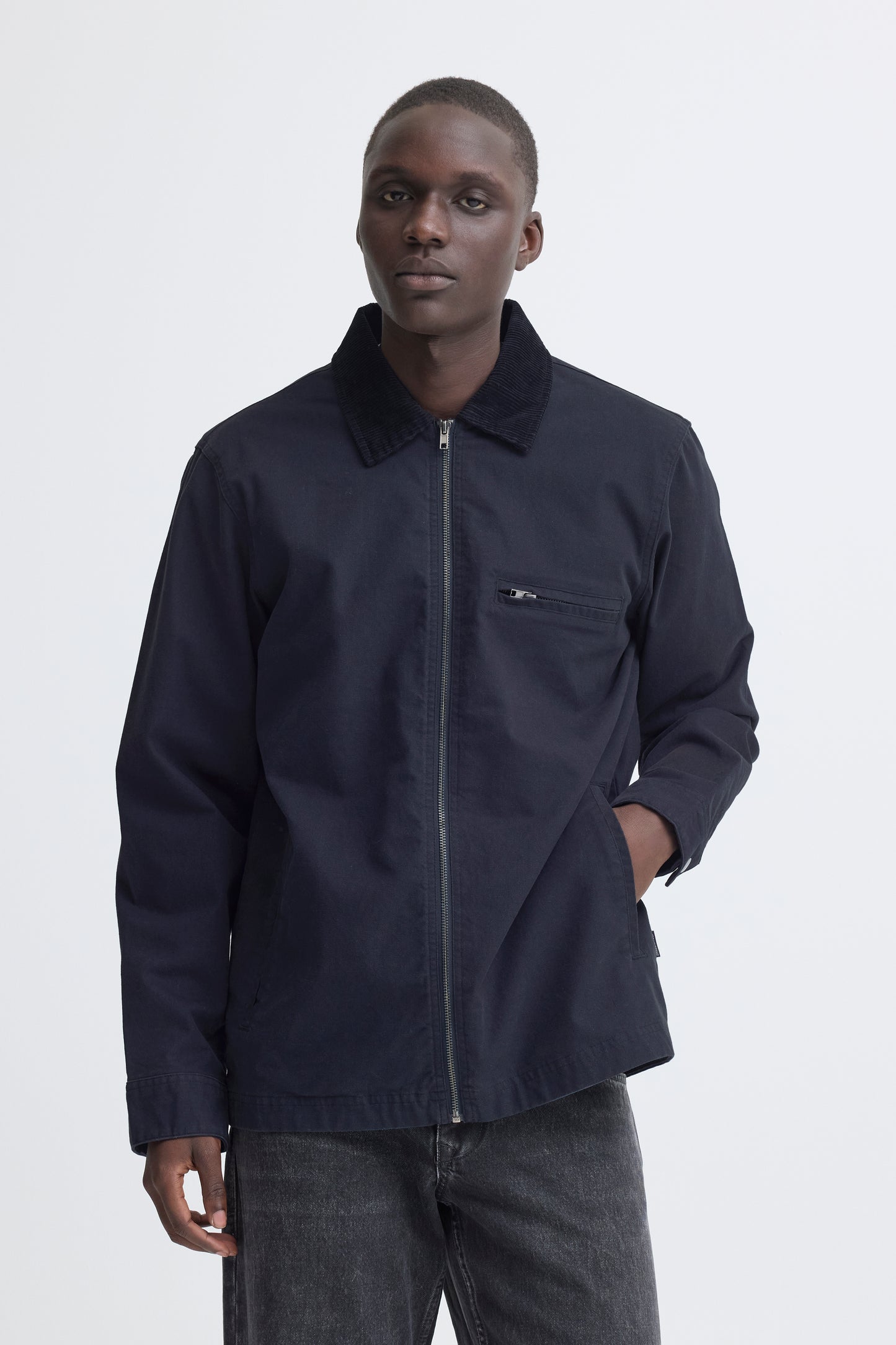 Man wearing a dark blue jacket on a white background