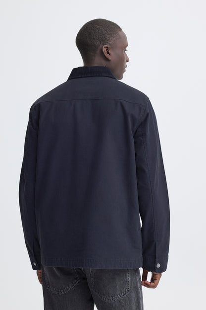Man wearing a dark jacket on a white background