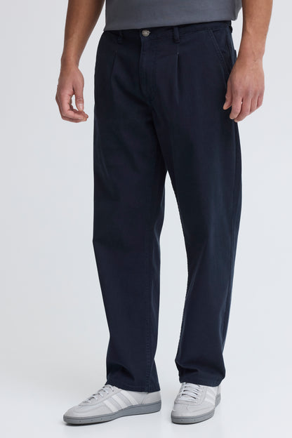 Person wearing navy pants on a white background