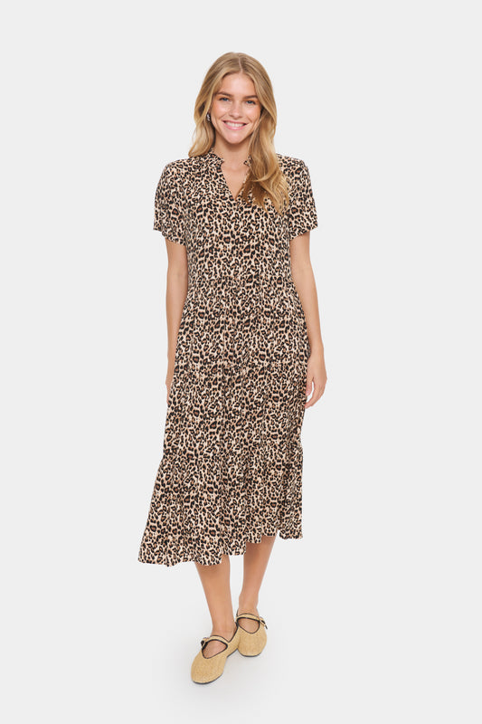 Woman wearing a patterned dress on a white background