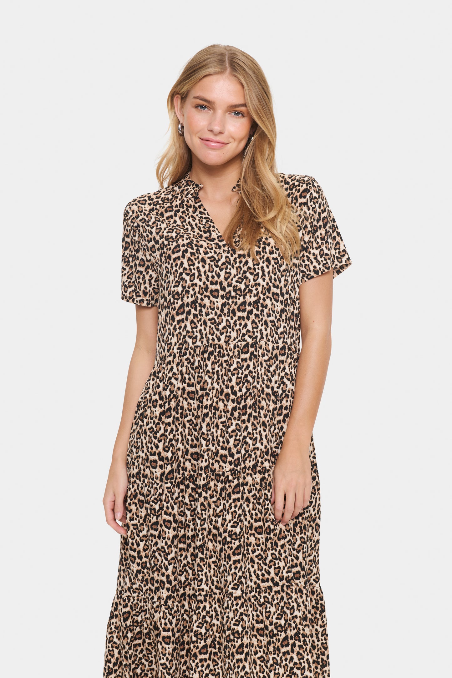 Woman wearing a leopard print dress on a white background