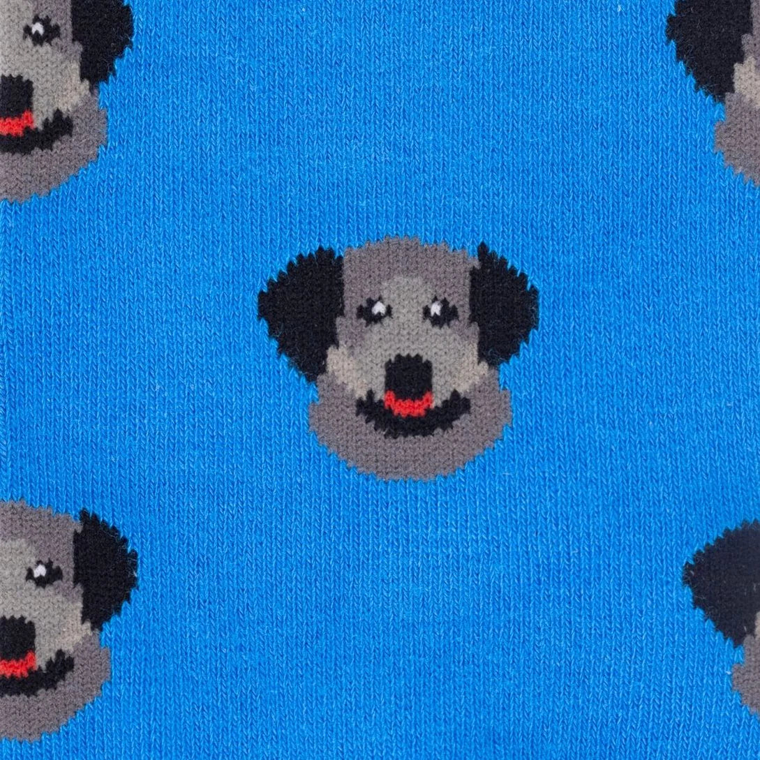 Blue knit fabric with a repeating pattern of stylized gray dog faces with black ears and red tongues.