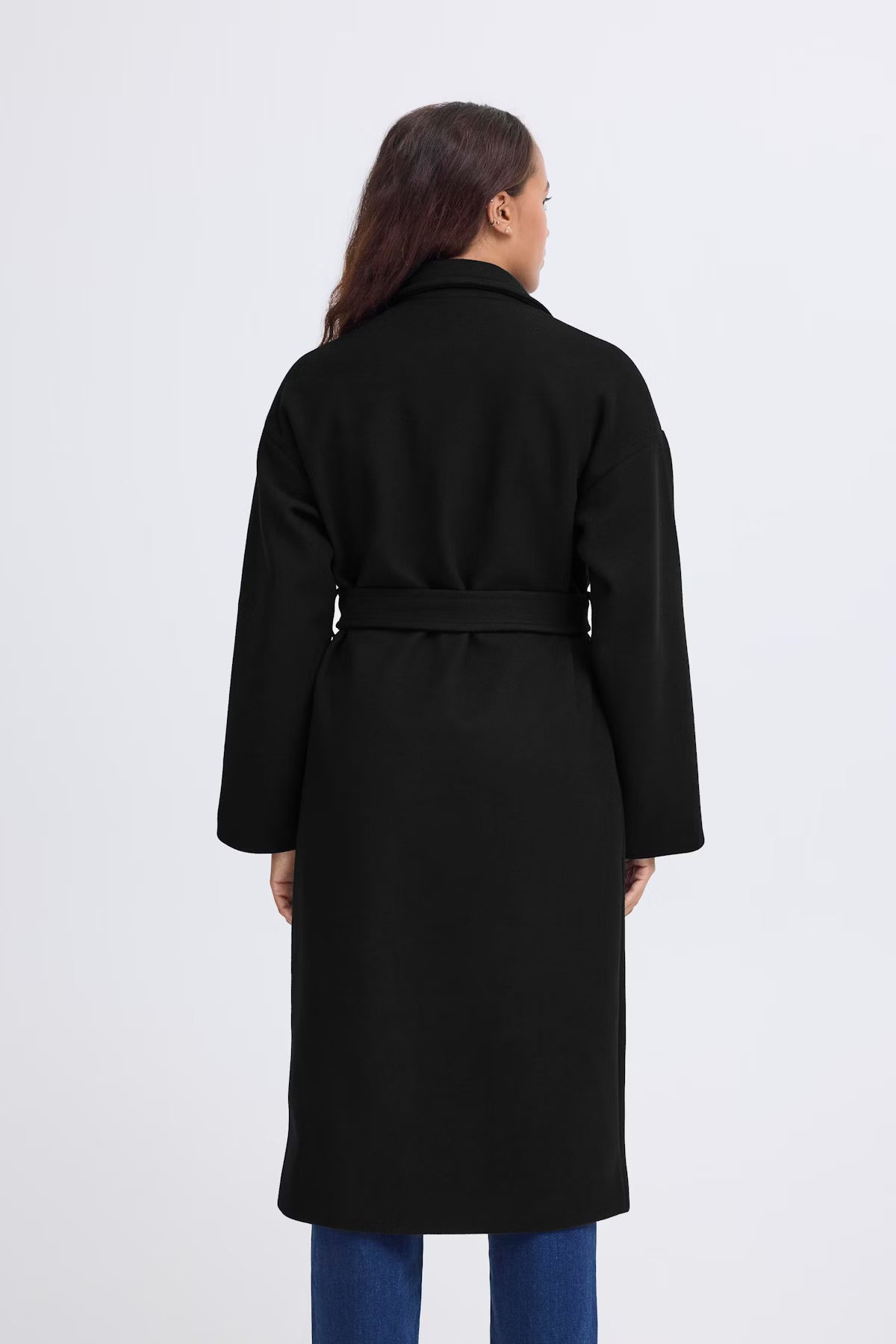Person wearing a black coat on a white background