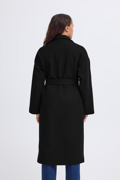 Person wearing a black coat on a white background