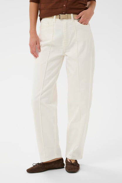Person wearing white pants and brown shoes on a white background